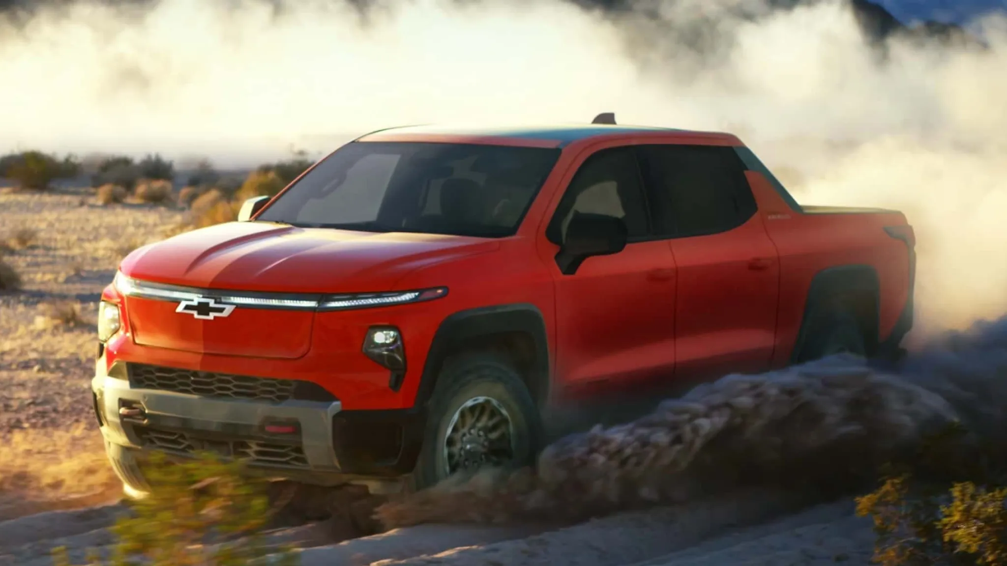 Silverado EV Trail Boss Red pickup truck driving off-road in desert