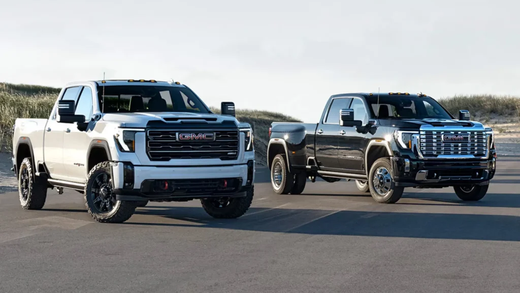 Two GMC pickup trucks parked on the road