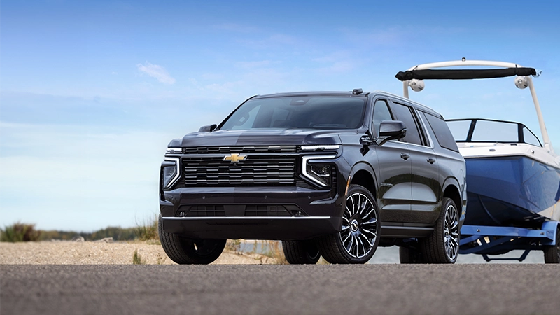 the 2025 chevrolet suburban towing a boat in right hand drive by autogroup international