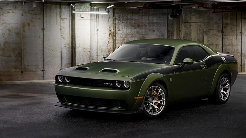 Dodge Challenger in Green Hornet parked in grunge garage. Converted to right hand drive by autogroup international