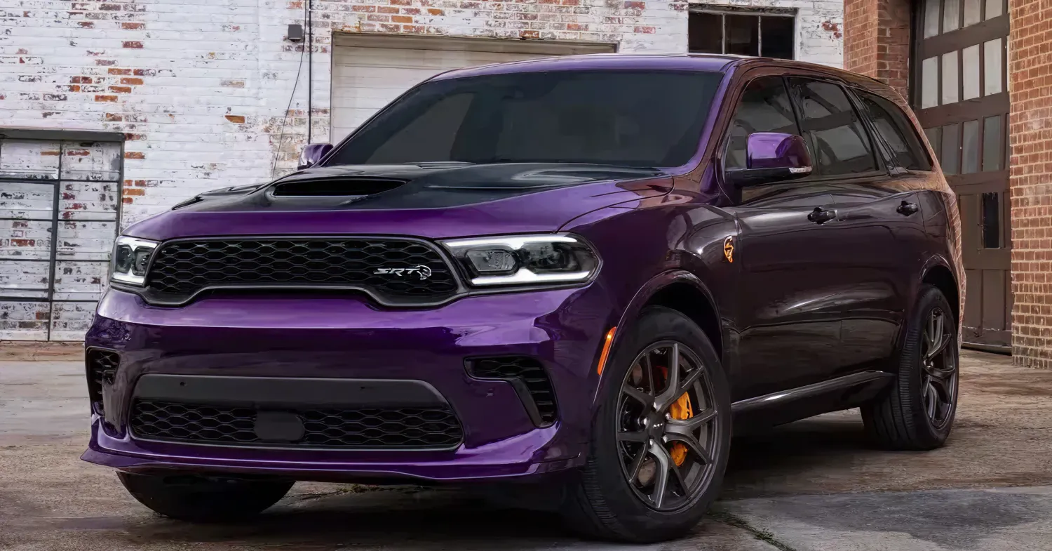 Purple performance SUV parked near brick building