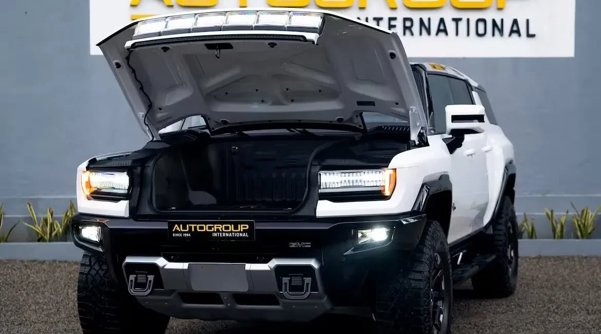 White electric SUV with hood open outdoors